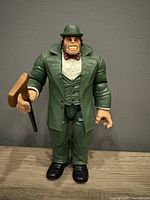 Front view of Mr. Hyde Build a Figure action figure in green suit holding brown cane