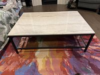 Top view of the large coffee table showing the marble surface and steel frame.