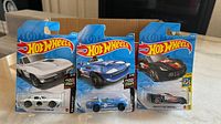Three Hot Wheels Corvette cars in original blister packaging front view