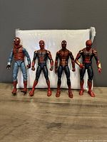 Front view of 4 Spider-Man Marvel Legends figures showing Homemade suit, Civil War suit, and two Iron Spider suits.