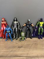 Front view of all six Marvel Legends figures including Scarlet Witch, Beast, Iron Man Dr Doom, X-Force Wolverine, mini Dr Doom, and The Prowler