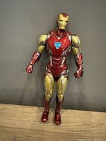 Front view of the Iron Man figure standing upright showing detailed chest arc reactor and red and gold armor.