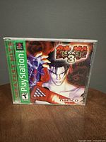 Front cover of PlayStation Tekken 3 game case showing character art, Namco branding, and Greatest Hits label.