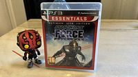 Photo of the PS3 game case featuring Star Wars The Force Unleashed Ultimate Sith Edition with Darth Maul Funko Pop figure beside it.