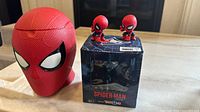 Popcorn head Spider-Man figurine alongside unopened Blue Jay edition box with two mini Spider-Man figurines on top