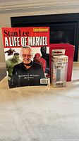 Special Edition magazine cover showing Stan Lee with Marvel characters Hulk and Spider-Man, and Stan Lee Pop PEZ dispenser in box featuring Stan Lee character design in front.