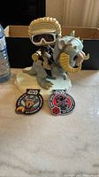 Front view of Han Solo Funko Pop on Tauntaun with two embroidered Star Wars patches in front