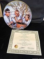 Front of the Three Stooges Tree Surgeons collectors plate showing the detailed illustration and the certificate of authenticity partly visible below.