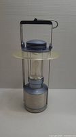 Photo of large portable lantern with silver base and transparent glass enclosure