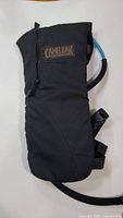 Black Camelbak hydration pack with hydration tube and protective mouthpiece cover