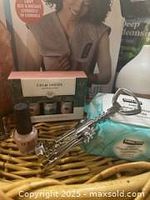 Photo showing multiple items including Mario Badescu facial spray, makeup remover wipes, nail polish set, and metallic corkscrew in a wicker basket.
