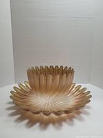 Rose gold Studio Nova Solaris glass bowl and plate with petal-shaped swirl design