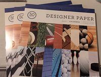 Three packs of Colorbok Designer Paper in sports theme unopened, each pack contains 50 sheets with 25 unique designs.