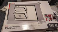 Box front showing image of wall mount pockets and memo board labeled 'Lola' by Krooom, eco-friendly and snap together design.