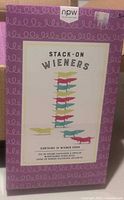 Front of the Stack-On Wieners game box highlighting the product packaging with colorful stacked plastic wiener dog images and brand npw