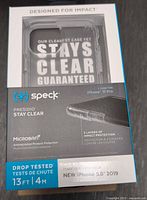 Front view of original Speck Presidio Stay Clear phone case packaging stating designed for impact, clear case stays clear guaranteed, Microban antimicrobial protection, and compatibility with iPhone 11 Pro 5.8 inch.