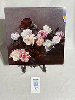 Front side of album cover showing floral still-life painting with roses and other flowers.