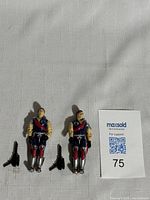 Lot layout showing Tomax and Xamot 1980s GI Joe figures with guns alongside MaxSold lot card