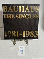 Front of sleeve with gold Bauhaus The Singles 1981-1983 text on black background.