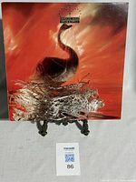 Front cover of Depeche Mode Speak and Spell LP featuring swan artwork in orange tones.