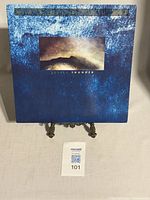 Front cover of the 'Lovely Thunder' vinyl album showing artist name and artwork on blue textured background.