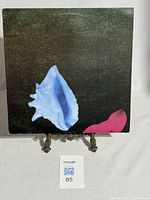 Front cover of the vinyl record sleeve showing abstract art of blue and red shells on a black background