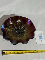 Top-down view of the amethyst purple carnival glass bowl showing detailed floral pattern and iridescent finish.