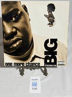 Front cover of The Notorious B.I.G. "One More Chance" vinyl single with close-up face image and child figure.