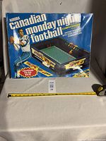 Photo of the game box showing the Aurora Canadian Monday Night Football branding and Canadian Football League rules.
