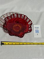 Front angled view of the vivid red and orange gradient vintage Fenton Amberina glass basket weave bowl