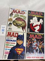 All four Mad Magazine comics displayed together showing their colorful, detailed covers.