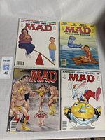 Top-down photo showing all 4 Mad Magazine comic issues with visible colorful covers.
