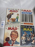 Four vintage Mad Magazine comic books arranged side by side showing front covers.