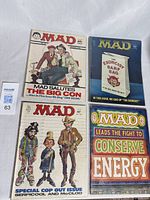 Lot of four vintage Mad magazines, various covers visible.