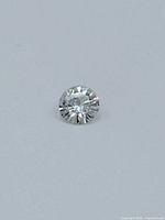 Top-down view of round brilliant diamond on white background