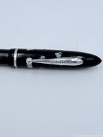 Close-up of clip marked 'Shaefer' with mother of pearl accents visible on pen barrel.