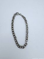 Full view of the sterling silver chain bracelet laid out flat on a white background.