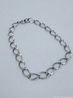 Sterling silver chain bracelet laid flat to show chain style and clasp.