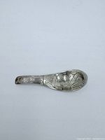 Front side of the sterling silver Indigenous spoon pendant showing detailed engraved design.