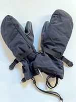 Pair of black Burton kids XL winter gloves laid flat, showing overall shape, wrist straps, and button buckles.