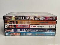 Five Jillian Michaels fitness DVDs stacked showing titles: Killer Body, No More Trouble Zones, Yoga Meltdown, Killer Abs, and 30 Day Shred.