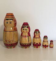 Front view of the set of 5 Russian nesting dolls arranged by size.