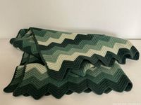 Folded view of vintage crocheted lap blanket showing texture and layered folds.