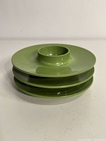 Stacked view of the three green Melmac egg cups showing circular flat base and cup holder in center.