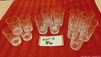Top-down perspective showing all 13 glasses arranged in 3 groups on a red cloth.