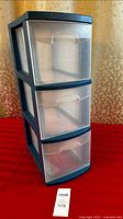 Front view of the 3 drawer plastic storage bin showing stacked translucent drawers in a dark blue frame.