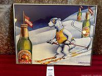 Full view of framed print showing skiing polar bear with Sun Country Cellars Cooler bottle and Dynastar flags.