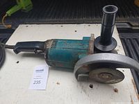 Makita 16 inch angle grinder, teal and black, heavily used with power cord and side handle attachment