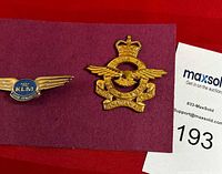 RCAF Hat Badge and KLM badge mounted on purple card, showing two aviation badges side by side.