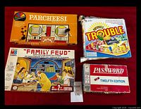 Photo showing all four boxed games Parcheesi, Family Feud, Trouble, Password.